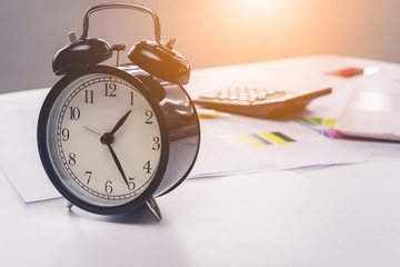 Traditional Clock and spreadsheet on desk with laptop, Business concept competition with time