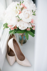 wedding bouquet of flowers and women's shoes before the wedding