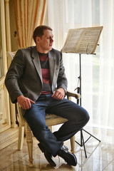 Portrait indoor of musician with score
