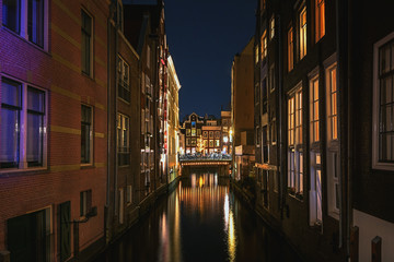 Fototapeta na wymiar Narrow canal in the old town of Amsterdam in the evening
