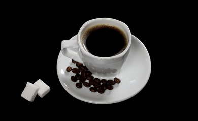 White cup of coffee with beans and sugar cubes isolated on black background