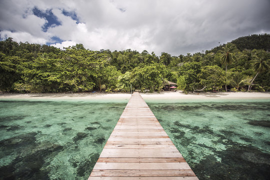 Fototapeta View of pier at Raja Ampat Islands against cloudy sky