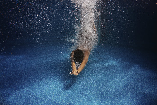Boy diving in swimming pool