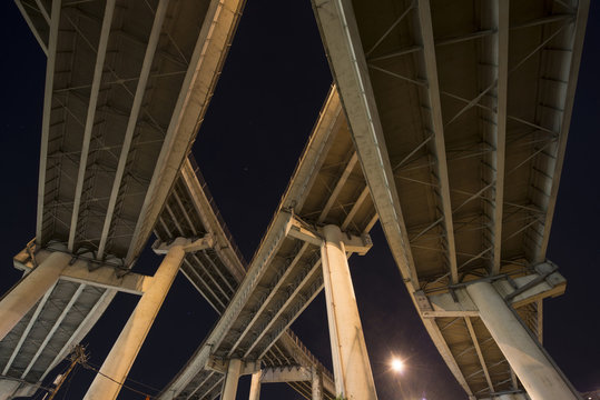 Low angle view of highway overpasses during night