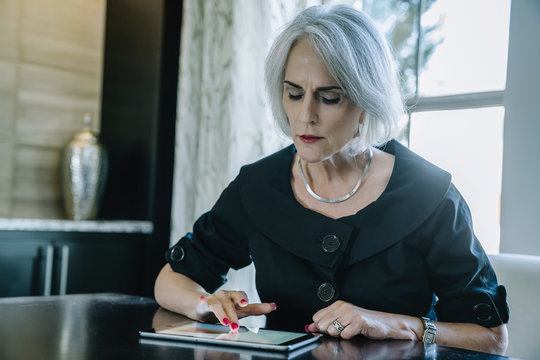 Businesswoman using digital tablet while sitting in office