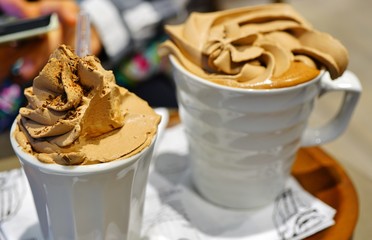 Mug of hot chocolate with chocolate whipped cream on top 