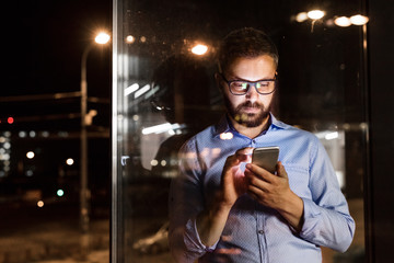 Businessman in the office at night working late.