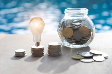 stack money coins with growing light bulb concept