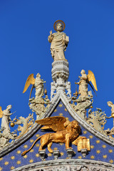 Fototapeta na wymiar Saint Mark, angels and lion on top of Basilica