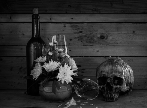 Still life with human skull with wine and  flower
