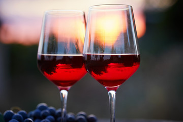 Two glasses of red wine at sunset
