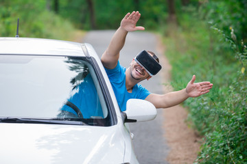 Man using car driving video simulation and wearing virtual reality glasses