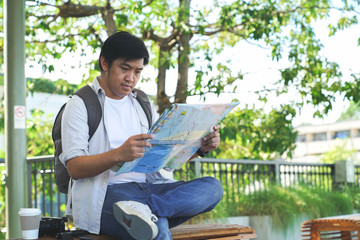 Tourist Stock Photographer Read a map direction during Travel around Bangkok Landmark in Thailand