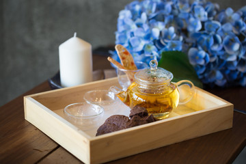 Cup of tea with a cookie in the background. Vintage style