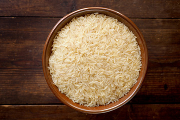Bowl of rice on textured wooden table
