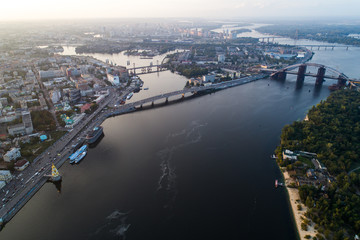 Fototapeta premium Panoramic view of a modern city with a river, unfinished bridge and park part of the city