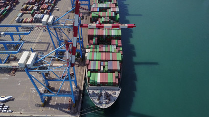 Fully loaded container ship docked at freight port terminal