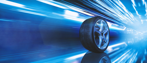 Reifen auf Alufelge fährt schnell durch eine Stadt bei Nacht © Shutter81