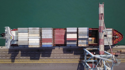 LARGE container ship fully loaded with containers and cargo - aerial 4k view top down