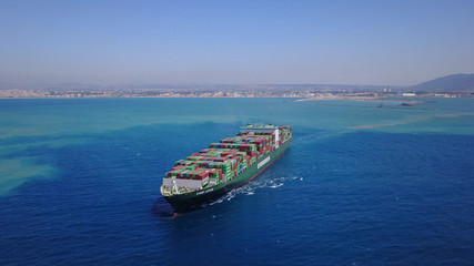 LARGE container ship fully loaded with containers and cargo - aerial 4k view top down