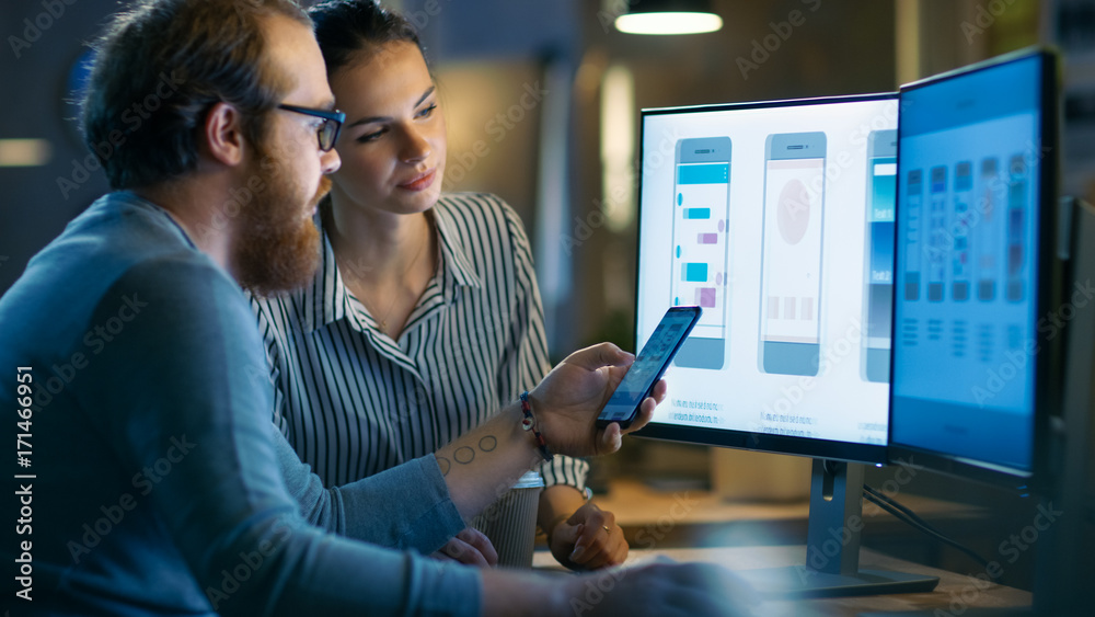 Poster handsome male and beautiful female mobile application designers test and discuss new app features. t