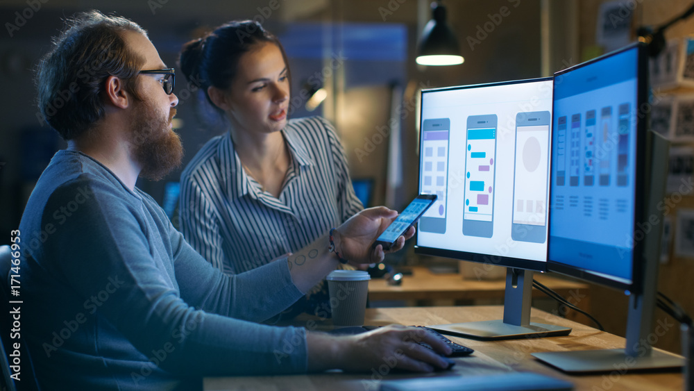 Aufkleber handsome male and beautiful female mobile application designers test and discuss new app features. t