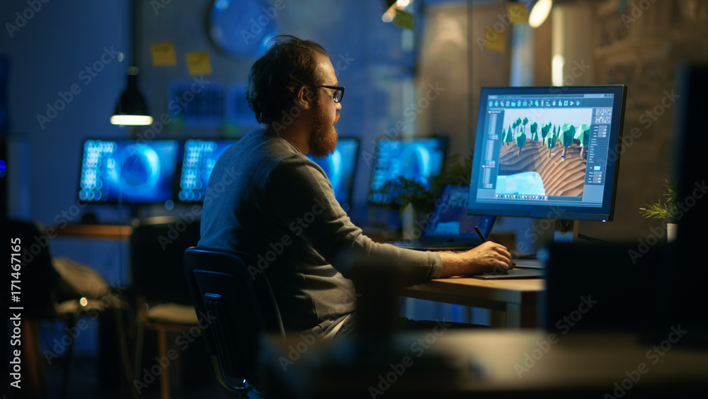 Poster Male Mobile Application Developer Works with Graphics on His Personal Computer with Two Monitors. He Works Late at Night, in an Empty Office.