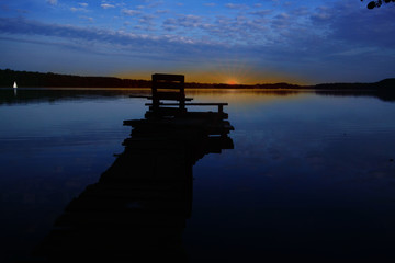Blue hour before sunrise on the lake with a wooden pier