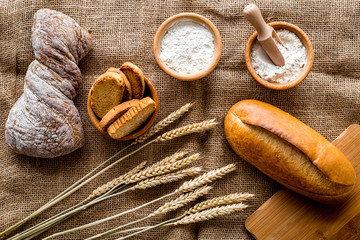 baking fresh wheaten bread on bakery work table background top view