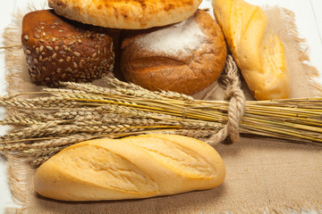 Assortment of bread on a white wooden background