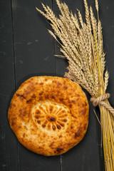 Bread loaf on a black wooden background