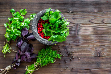 close up of ingredients for making spices and herbs in mortar wooden background top view mock up