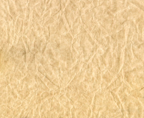 Texture of crumpled paper. Brown crumpled parchment.
