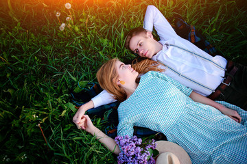 young couple lying on the grass and relax, view from above