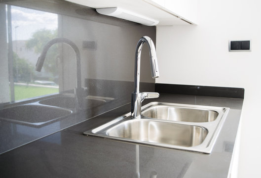A double bowl stainless steel kitchen sink in a modern style