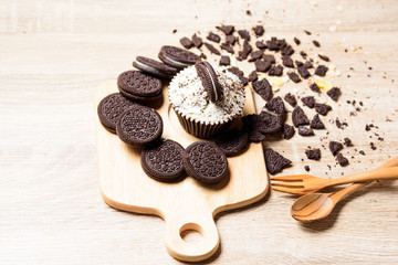Homemade Chocolate cupcakes and cookies are in wooden plates.