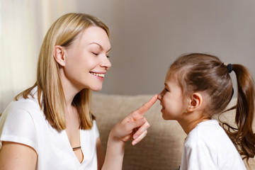 Beautiful mother is comforting his young frustrated daughter.