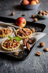 Fruit tartlets filled with caramelized apple pieces, cinnamon and walnuts