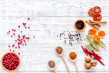 Spicy food cooking with spices and dry herbs light wooden kitchen desk background top view mockup