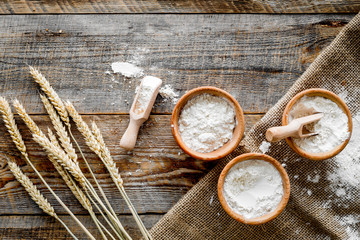 wheat and rye ear for flour production on wooden desk background top view
