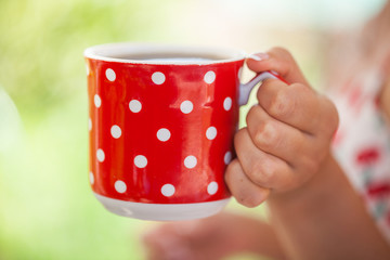 The girl is holding a mug of tea. Hot invigorating drink. for your design.