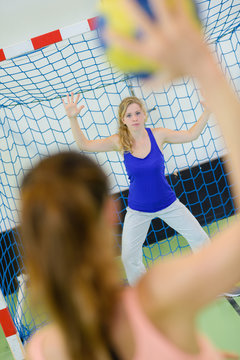 sportswoman throwing a handball ball