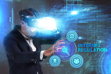 Business, Technology, Internet and network concept. Young businessman working in virtual reality glasses sees the inscription: Internet regulation