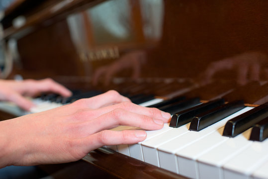 Closeup of hands on piano keyboard