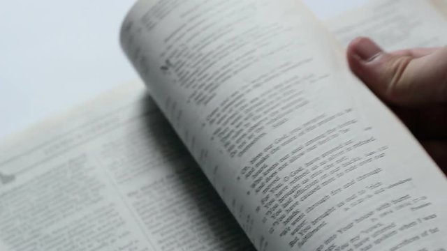 The Man Leafing Through The Page Of Bible