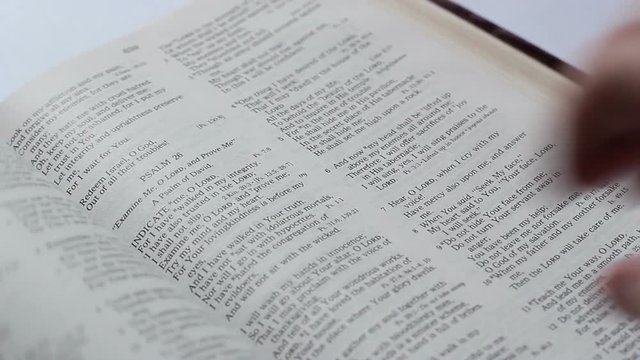 The Man Leafing Through The Page Of Bible