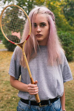 Pink-haired woman with retro badminton racket
