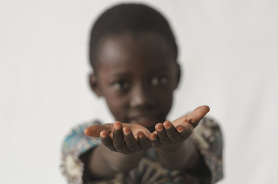 African boy holding his hands open as a concept, isolated on white and blurry background