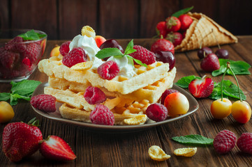Belgian waffles with berries, whipped cream and grated chocolate