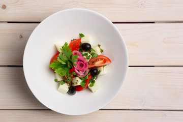 Salad with mozzarella, tomato and olives. Top view.